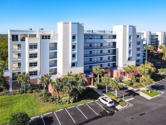 5300 S Atlantic Ave Unit 17-506, New Smyrna Beach, FL 32169 - view of apartment building / complex with uncovered parking