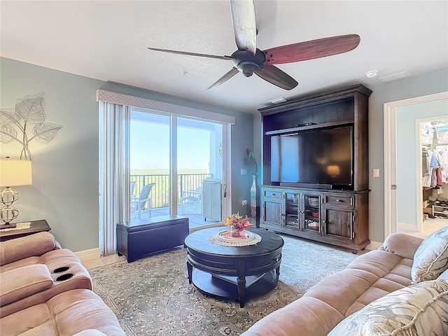 5300 S Atlantic Ave Unit 17-506, New Smyrna Beach, FL 32169 - living room featuring a ceiling fan and baseboards
