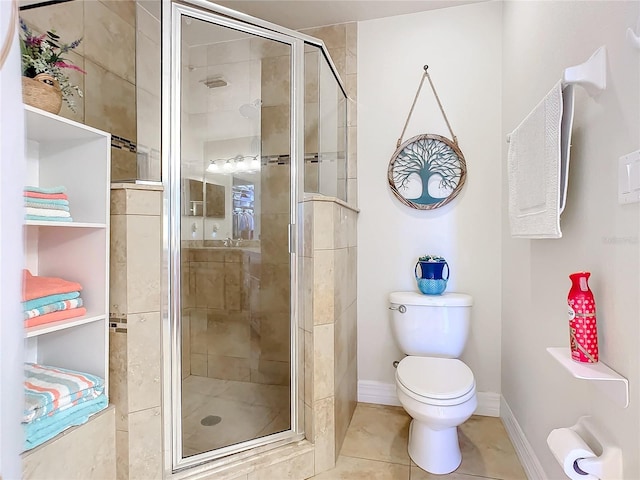 bathroom featuring tile patterned flooring, toilet, and an enclosed shower