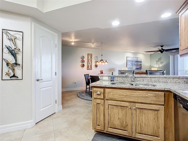 kitchen featuring dishwasher, sink, ceiling fan, and light stone counters