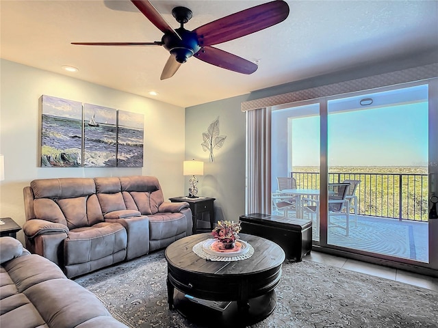 living room featuring tile patterned floors and ceiling fan