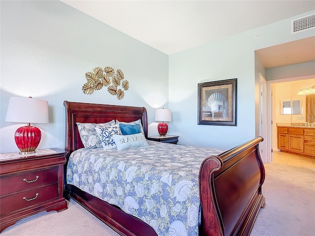 carpeted bedroom featuring ensuite bathroom