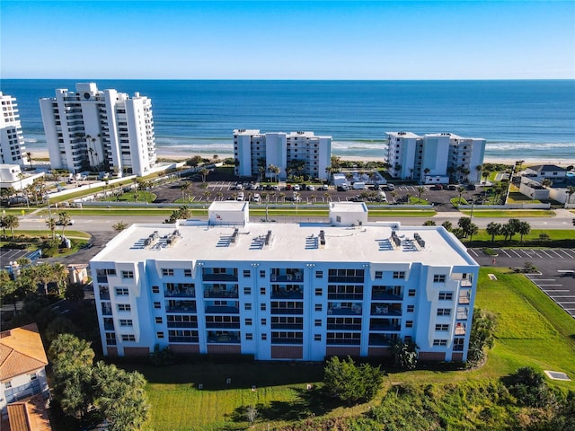 birds eye view of property featuring a water view and a beach view