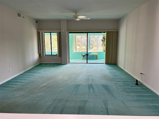 unfurnished room featuring a textured ceiling, carpet floors, and ceiling fan