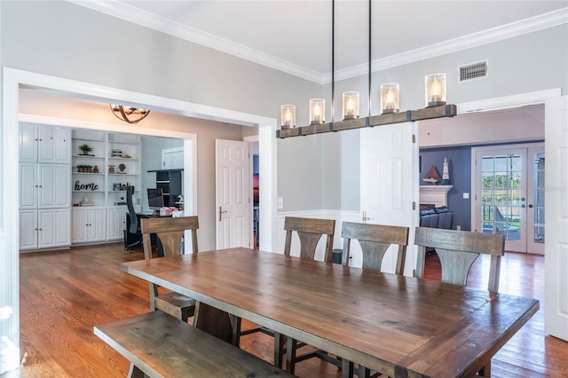 dining room with wood-type flooring and ornamental molding