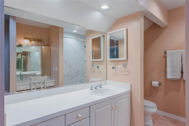 bathroom featuring vanity, lofted ceiling, tile patterned flooring, toilet, and tiled shower