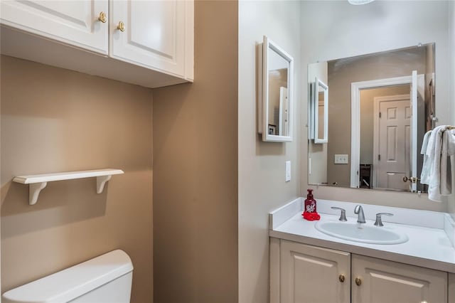 bathroom featuring vanity and toilet