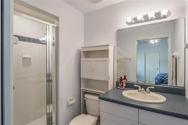 bathroom with vanity, toilet, and walk in shower