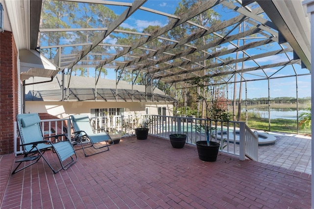 view of patio / terrace featuring a lanai and a water view