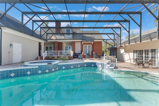 view of pool featuring glass enclosure, a patio area, an in ground hot tub, and french doors