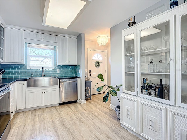 kitchen featuring appliances with stainless steel finishes, sink, and white cabinets