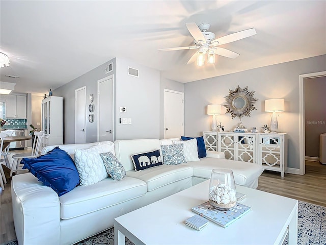 living room with hardwood / wood-style flooring and ceiling fan