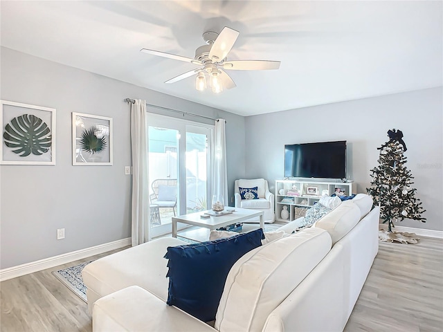 living room with ceiling fan and light hardwood / wood-style floors