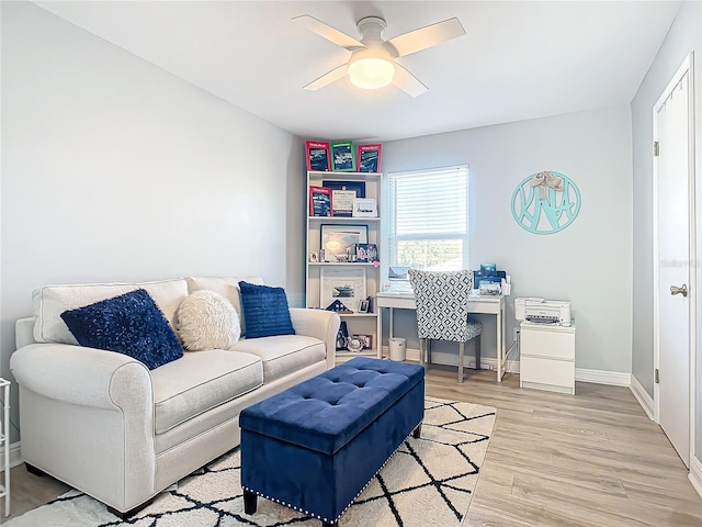 living room with ceiling fan and light hardwood / wood-style flooring