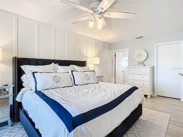 bedroom with light hardwood / wood-style flooring and ceiling fan