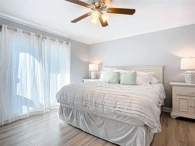 bedroom with crown molding, ceiling fan, and light hardwood / wood-style flooring