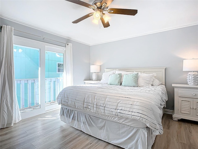 bedroom with multiple windows, hardwood / wood-style flooring, access to exterior, and ceiling fan