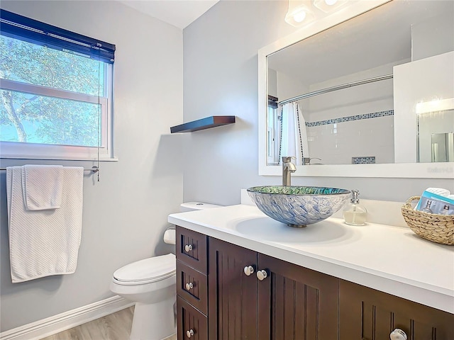 bathroom with vanity, hardwood / wood-style floors, curtained shower, and toilet