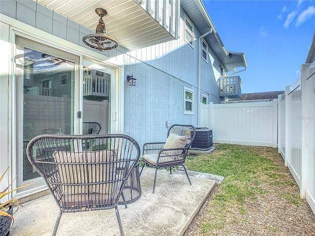 view of patio with central AC and ceiling fan