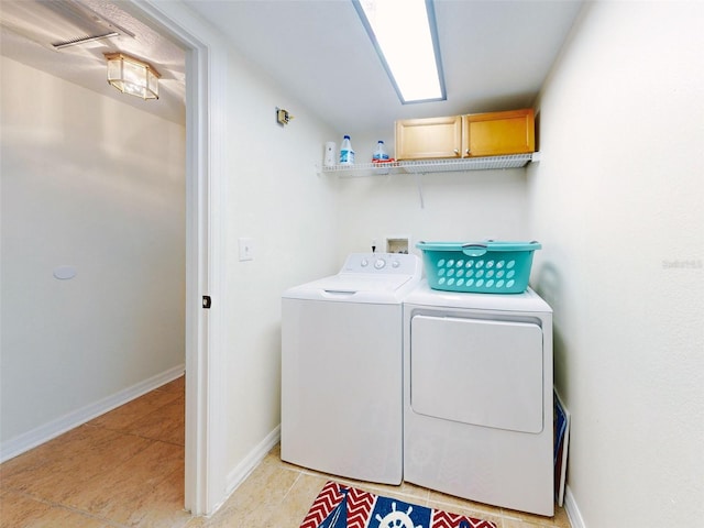 washroom with washing machine and clothes dryer and light tile patterned flooring