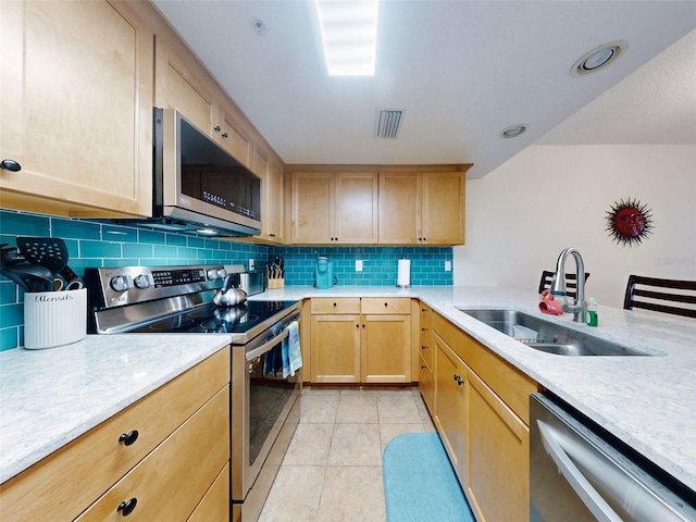 kitchen featuring light brown cabinetry, sink, light tile patterned flooring, and appliances with stainless steel finishes