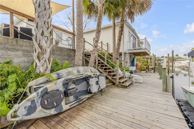 wooden terrace with a water view and a dock