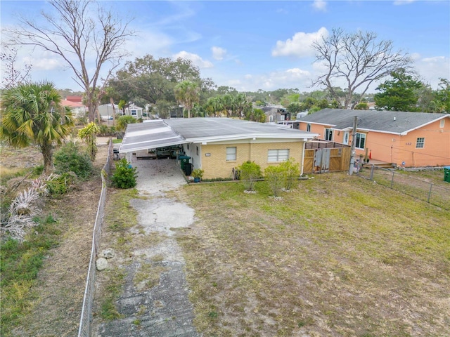 back of house featuring a carport