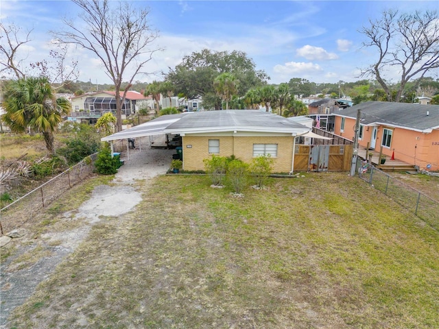 back of house featuring a carport