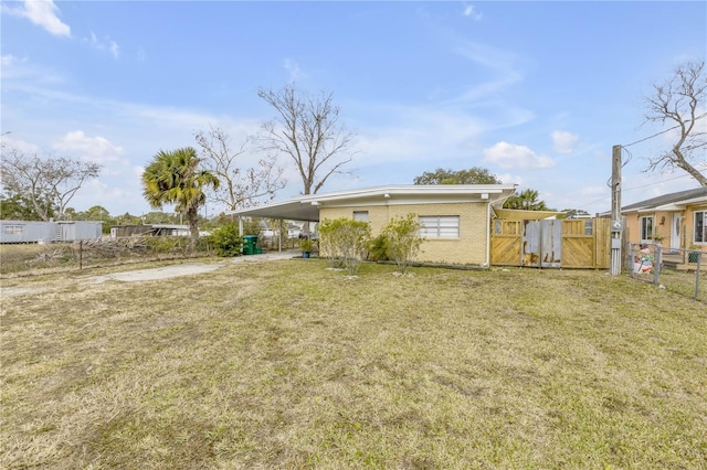 back of property featuring a yard and a carport