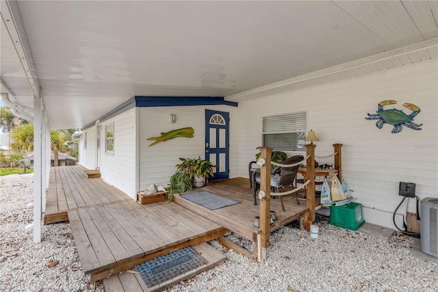 wooden deck featuring cooling unit