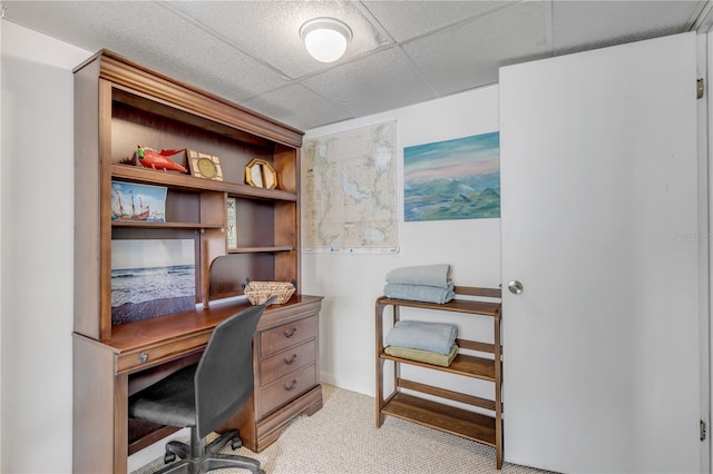 carpeted office space featuring a drop ceiling