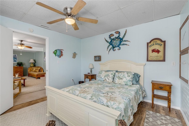 bedroom with hardwood / wood-style floors and ceiling fan