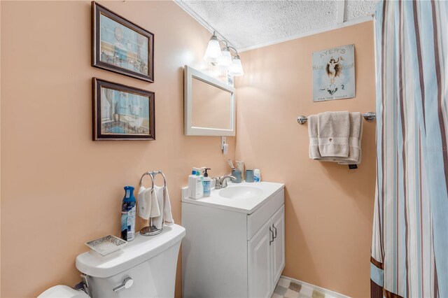 bathroom featuring crown molding, vanity, a textured ceiling, and toilet