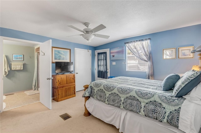 carpeted bedroom with a textured ceiling and ceiling fan