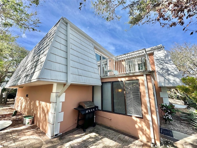 view of property exterior featuring a balcony