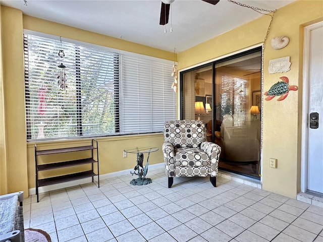 sitting room with ceiling fan and light tile patterned flooring