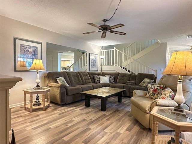 living room featuring ceiling fan and light wood-type flooring