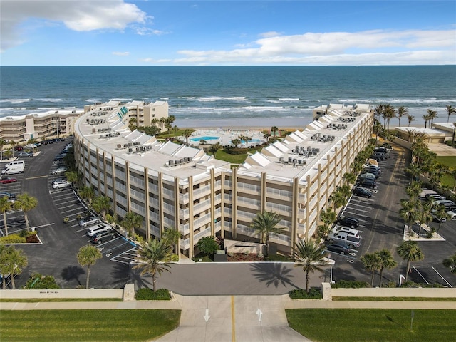 birds eye view of property featuring a water view and a view of the beach