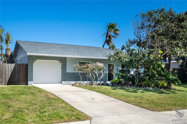 ranch-style house with a garage and a front lawn