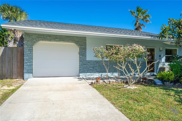 ranch-style house featuring a garage and a front lawn