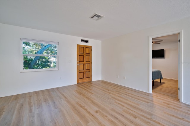 spare room featuring light hardwood / wood-style floors