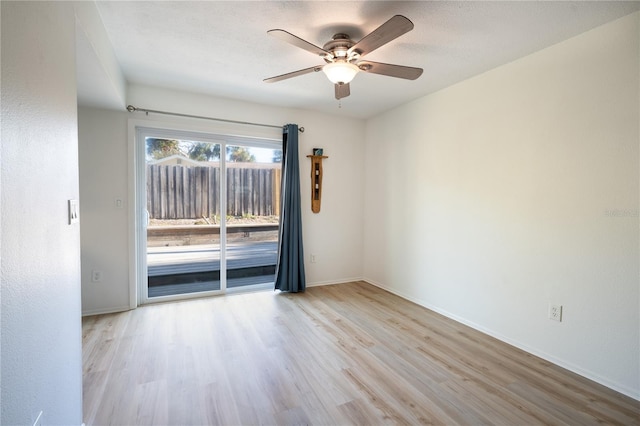 spare room with a textured ceiling, light hardwood / wood-style flooring, and ceiling fan