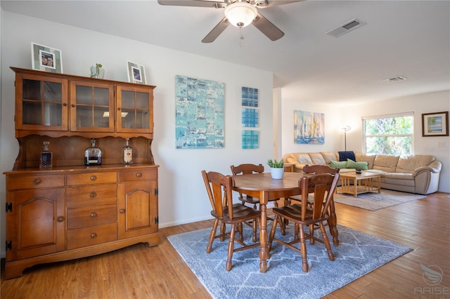 dining room with ceiling fan and light hardwood / wood-style floors