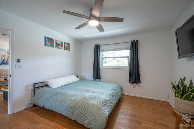 bedroom with hardwood / wood-style flooring and ceiling fan