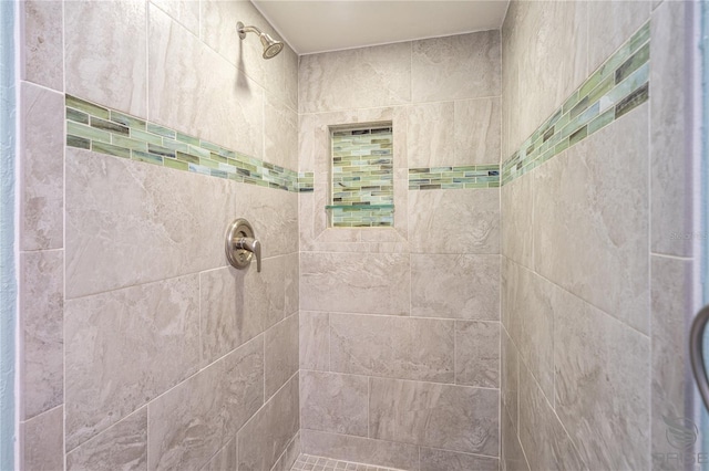 bathroom with tiled shower