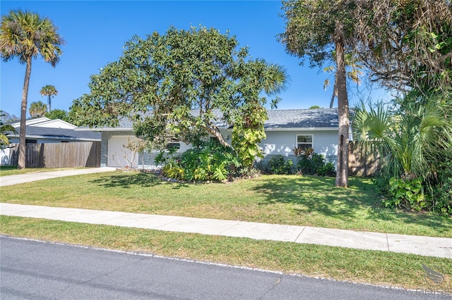 view of front of property with a garage and a front yard