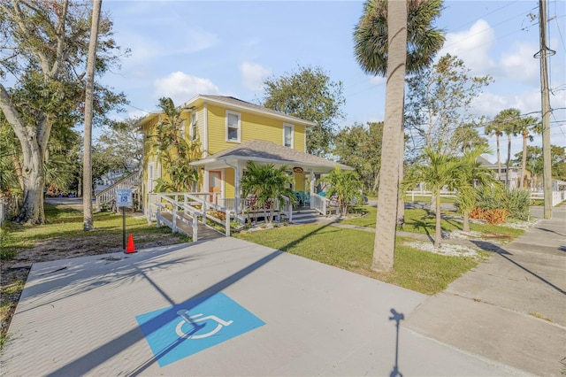 view of front of home with a porch and a front yard