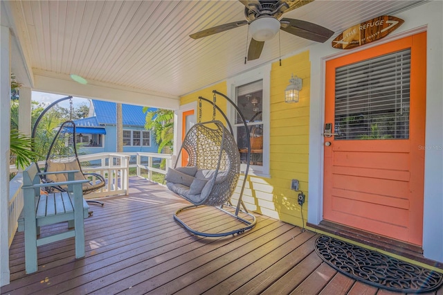 deck with ceiling fan and a porch