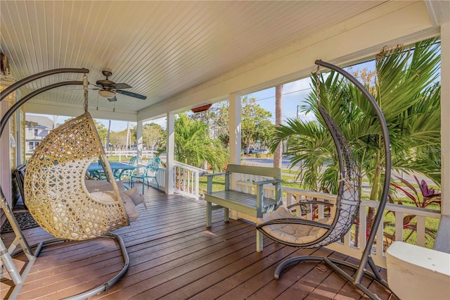 sunroom / solarium featuring ceiling fan and a healthy amount of sunlight