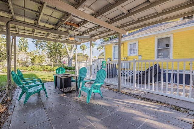 view of patio with ceiling fan and a fire pit